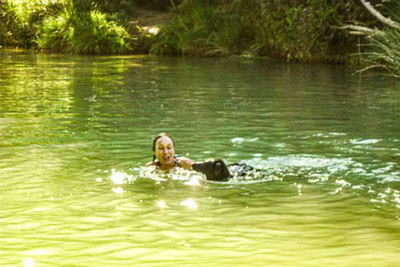 Wild swimming in a swimming hole with a nice random dog